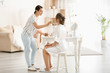© Pixel-Shot - Professional makeup artist working with young bride at home