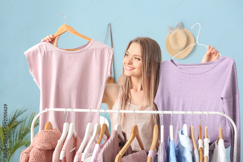 Young woman choosing clothes in dressing room