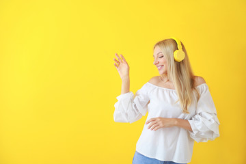 Sticker - Beautiful young woman listening to music on color background