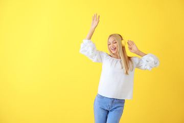 Sticker - Beautiful young woman listening to music on color background