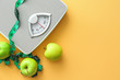 © Pixel-Shot - Scales, apples and measuring tape on color background. Weight loss concept