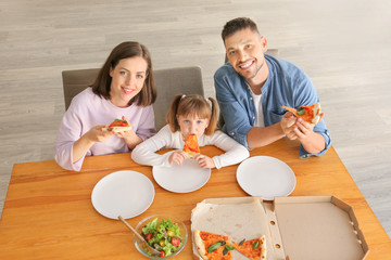 Poster - Happy family eating pizza at home