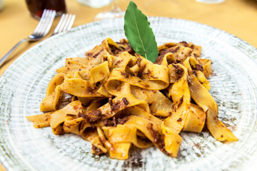 Dish with tagliatelle with wild boar meat sauce