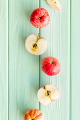 Autumn composition with fresh apples on green wooden background top view copy space