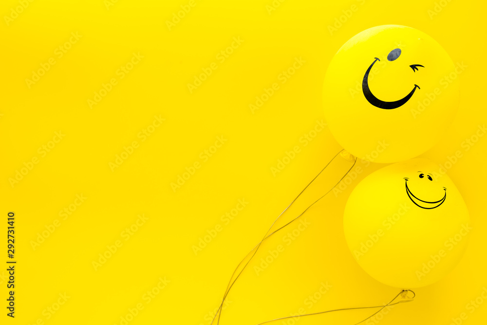 Happiness emotion. Yellow balloon with smile on yellow background top view space for text - obrazy, fototapety, plakaty 