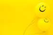 Leinwandbild Motiv Happiness emotion. Yellow balloon with smile on yellow background top view space for text