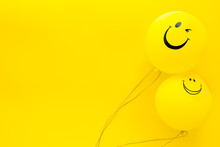 Happiness Emotion. Yellow Balloon With Smile On Yellow Background Top View Space For Text