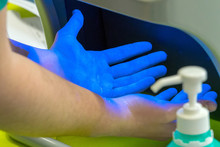 Someone Has Disinfected His Hands And Controls The Result Under Uv Light. Concept: Cleanliness And Protection Against Germs