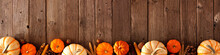 Autumn Bottom Border Banner Of Pumpkins And Fall Decor On A Rustic Wood Background With Copy Space