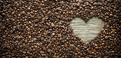 Wall Mural - Coffee beans in heart shape on rustic wooden