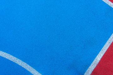 Colorful sports court background. Top view to red and blue field rubber ground with white lines outdoors