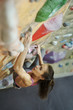 © vitaliymateha - Young Woman Rock climber is Climbing At Inside climbing Gym. slim pretty Woman Exercising At Indoor Climbing Gym Wall