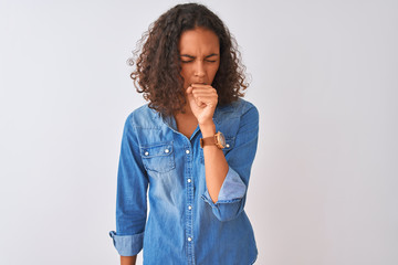 Poster - Young brazilian woman wearing denim shirt standing over isolated white background feeling unwell and coughing as symptom for cold or bronchitis. Healthcare concept.