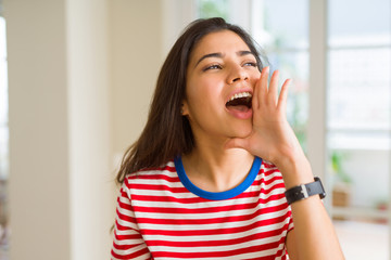 Poster - Beautiful young woman shouting and screaming with hand on mouth very excited