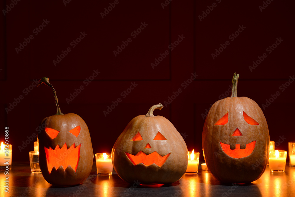 Halloween pumpkins with candles on dark background
