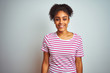 © Krakenimages.com - African american woman wearing casual pink striped t-shirt over isolated white background with a happy and cool smile on face. Lucky person.