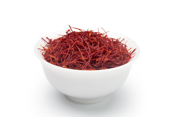 Wall Mural - Dried saffron in a white ceramic cup. Isolated on white background.