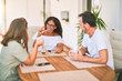 © Krakenimages.com - Beautiful family sitting on terrace drinking cup of coffee speaking and smiling