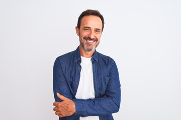 Wall Mural - Middle age handsome man wearing blue denim shirt standing over isolated white background happy face smiling with crossed arms looking at the camera. Positive person.