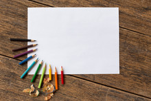 Colorful Colored Pencil And White Paper  On Wooden Background