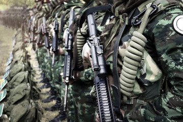 Thai soldiers stand in row.commando soldiers in camouflage uniforms gun in hand,close up of army and preparation for battle