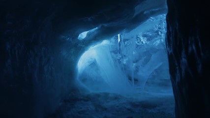 progressing in a dark ice cave in iceland.