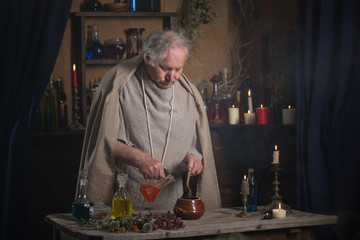 elderly alchemist monk brews  magic potion