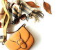 Autumn composition with women fashion  accessories top view on white background toned. Flat lay collage of female style look with bag, sunglasses, scarf,  autumn leaves. Copy space