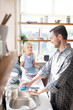 © zinkevych - Daughter holding plate while daddy washing the dishes