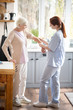 © zinkevych - Pensioner having some ache in arm showing it to nurse