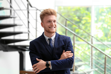 Wall Mural - Portrait of handsome young man in elegant suit indoors