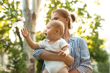 Sticker - Teen nanny with cute baby in park on sunny day