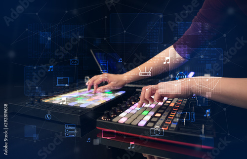 Fotomural Hand remixing music on midi controller with play music and multimedia concept