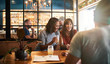 © mavoimages - Diverse young friends laughing over drinks together in a bar