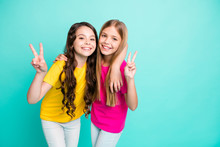 Photo Of Two Excited Cheerful Nice Cute Girls Showing You V-sign While Isolated With Teal Background