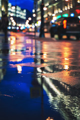 Wall Mural - Night street in a big city after rain, night lights, bokeh, blur and reflection in a puddle