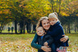 © Nana_studio - Beautiful young mother with daughter and son are walking in the autumn park. close-up portrait