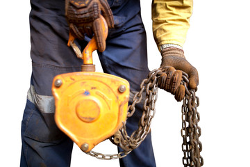 Wall Mural - Rigger high risk worker wearing heavy duty glove, doing checking inspection a  heavy duty 3 tones lifting chain block with isolated white background on construction mine site Perth city, Australia 