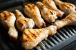 © Tatiana - Marinated chicken legs fried on the hot flaming BBQ grill.