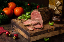 Juicy Roast Beef With Spices Sliced On Cutting Board, Delicious Meat, Traditional Food. Christmas Holidays, New Year, Menu On Dark Background