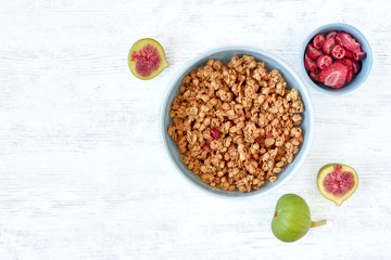 Poster - Granola for healthy breakfast. Bowl with granola and fresh fig and dried berries, top view	