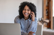 © mavoimages - Laughing female entrepreneur talking with a client on her cellphone