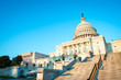 Golden afternoon view of the western side of the Capitol Building in Washington DC, USA under bright blue sky