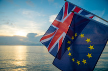 European Union And British Union Jack Flags Flying Together As The Sun Rises On A New Era On The Relationship Between The EU And The UK After Brexit