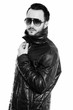 © Ranta Images - Studio shot of cool young man holding leather jacket