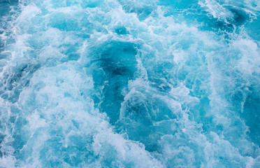 Sea surface texture. Blue water background. Blue sea water mesh. Motor boat trail on blue ocean surface. Cruise liner or ship tail