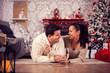 © DC Studio - Beautiful young woman holding hands and giving affection to her boyfriend on christmas day