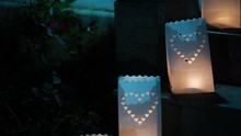 Paper Bag Lanterns On Stairs. Candle Light. Pierced In A Heart Shape. Romantic