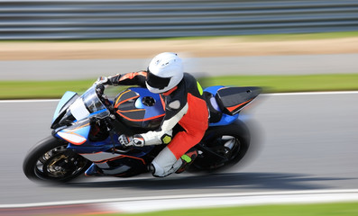 Wall Mural - Racing bike rider leaning into a fast corner