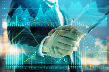 Double exposure of financial chart on cityscape background with two businessmen handshake. Concept of financial analysis and investment opportunities